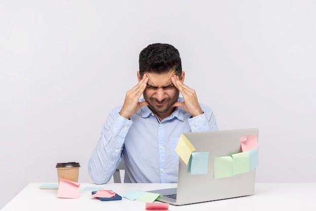 Migraine of stressful job. depressed man employee sitting in office, clasping head temples, suffering headache and tension, worried about problems at work. studio shot isolated on white background | Premium Photo