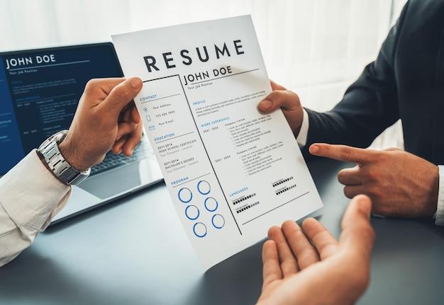 A person holding a resume on a paper | Premium Photo